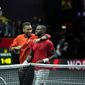 Team World&#39;s Felix Auger-Aliassime, left, hugs teammate Frances Tiafoe after the latter won the singles tennis match against Team Europe&#39;s Stefanos Tsitsipas on the third day of the Laver Cup tennis tournament at the O2 arena in London, Sunday, Sept. 25, 2022. (AP Photo/Kin Cheung)