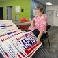 Carol Discher, a volunteer for the reelection campaign for Rep. Marcy Kaptur, D-Ohio,  stacks yard signs in Toledo, Ohio, on Saturday, Sept. 17, 2022. Kaptur appeared with President Joe Biden during his July visit to Ohio but has since produced an ad saying she “doesn’t work for Joe Biden,” evidence of how some Democrats are struggling with how much to embrace -- or distance themselves -- from the president ahead of November’s midterm elections. (AP Photo/Will Weissert)