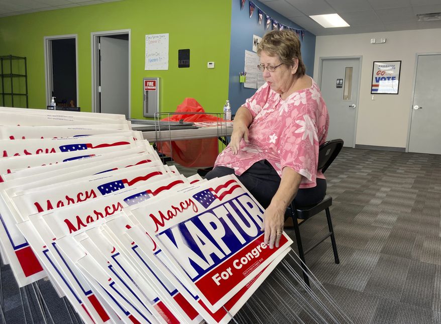 Carol Discher, a volunteer for the reelection campaign for Rep. Marcy Kaptur, D-Ohio,  stacks yard signs in Toledo, Ohio, on Saturday, Sept. 17, 2022. Kaptur appeared with President Joe Biden during his July visit to Ohio but has since produced an ad saying she “doesn’t work for Joe Biden,” evidence of how some Democrats are struggling with how much to embrace -- or distance themselves -- from the president ahead of November’s midterm elections. (AP Photo/Will Weissert)