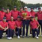 USA team captain Davis Love III, white hat, and his team pose for a photo with the Presidents Cup trophy after defeating the International team in match play at the Presidents Cup golf tournament at the Quail Hollow Club, Sunday, Sept. 25, 2022, in Charlotte, N.C.(AP Photo/Julio Cortez)