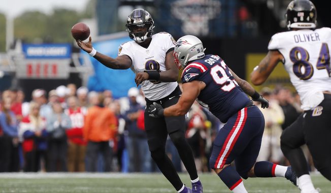 Baltimore Ravens quarterback Lamar Jackson (8) passes under pressure from New England Patriots defensive end Lawrence Guy (93) in the first half of an NFL football game, Sunday, Sept. 25, 2022, in Foxborough, Mass. (AP Photo/Paul Connors)