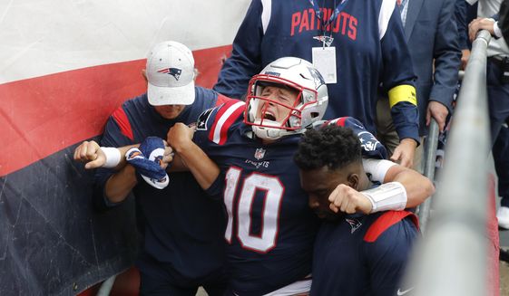 New England Patriots quarterback Mac Jones (10) is helped off the field after suffering a leg injury with less than two minutes to play in the second half of an NFL football game against the Baltimore Ravens, Sunday, Sept. 25, 2022, in Foxborough, Mass. (AP Photo/Michael Dwyer) **FILE**