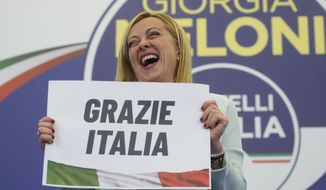 Far-Right party Brothers of Italy&#39;s leader Giorgia Meloni shows a placard reading in Italian &quot;Thank you Italy&quot; at her party&#39;s electoral headquarters in Rome, early Monday, Sept. 26, 2022. Italians voted in a national election that might yield the nation&#39;s first government led by the far right since the end of World War II. (AP Photo/Gregorio Borgia)
