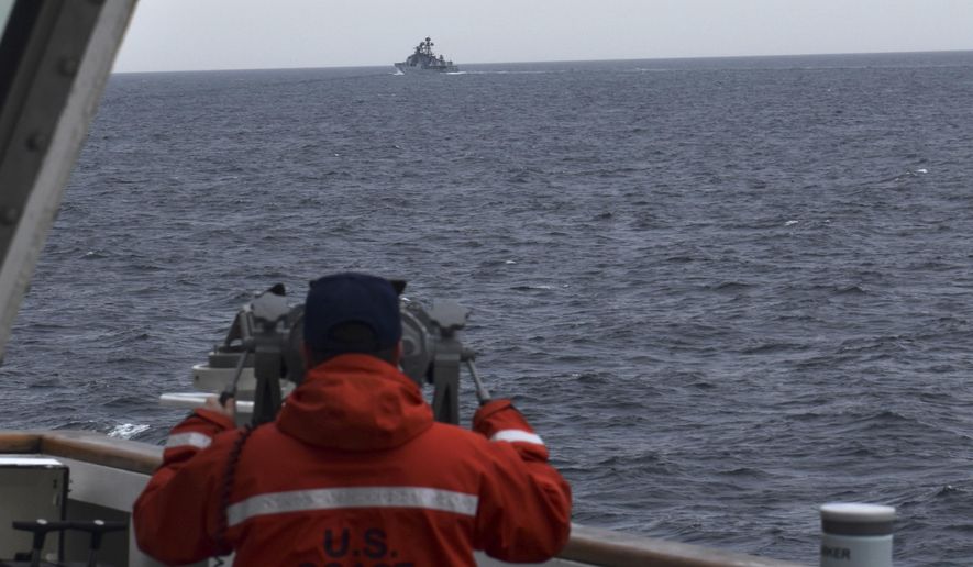 In this photo provided by the U.S. Coast Guard, a Coast Guard Cutter Kimball crew-member observes a foreign vessel in the Bering Sea, Monday, Sept. 19, 2022. The U.S. Coast Guard cutter on routine patrol in the Bering Sea came across the guided missile cruiser from the People&#x27;s Republic of China, officials said Monday, Sept. 26.  (U.S. Coast Guard District 17 via AP)