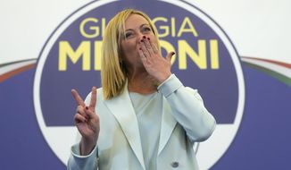 Far-Right party Brothers of Italy&#39;s leader Giorgia Meloni flashes the victory sign at her party&#39;s electoral headquarters in Rome, early Monday, Sept. 26, 2022. Italian voters rewarded Giorgia Meloni&#39;s euroskeptic party with neo-fascist roots, propelling the country toward what likely would be its first far-right-led government since World War II, based on partial results Monday from the election for Parliament. (AP Photo/Gregorio Borgia)