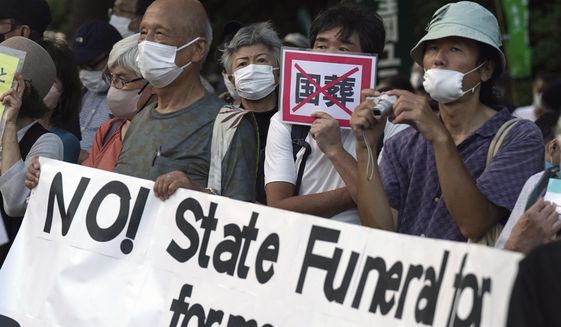 People protest outside Diet against the state paying for Japan&#39;s former Prime Minister Shinzo Abe&#39;s funeral in Tokyo on Aug. 31, 2022. A rare state funeral Tuesday, Sept. 27 for the former prime minister who was assassinated in July, has split Japan. (AP Photo/Eugene Hoshiko, File)
