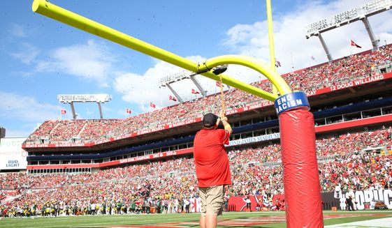 Honey bees are swept from an upright at the beginning of the NFL football game between the Tampa Bay Buccaneers and the Green Bay Packers on Sunday, Sept. 25, 2022, at Raymond James Stadium in Tampa, Fla. (Douglas R. Clifford/Tampa Bay Times via AP) **FILE**