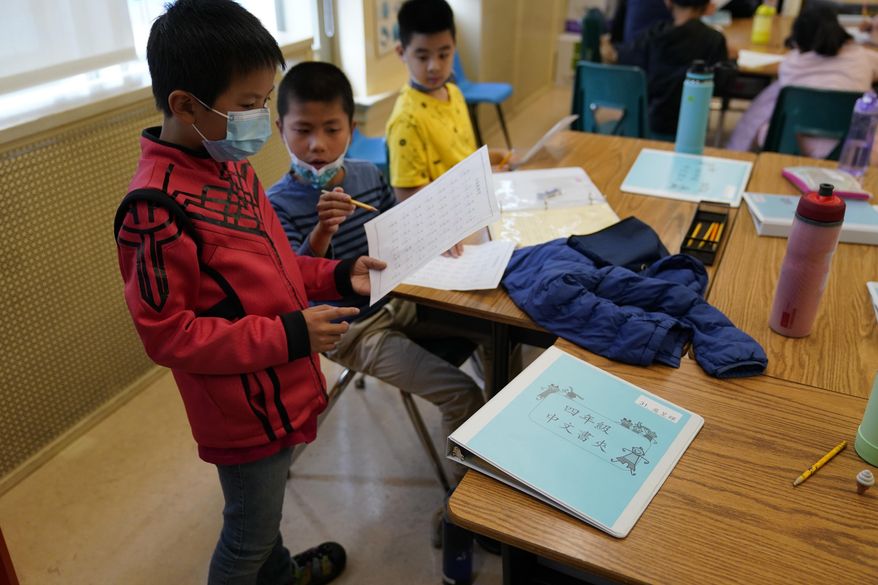Fourth grade math students look over an exercise at the Alice Fong Yu school in San Francisco, Tuesday, Aug. 30, 2022. The school is the nation&#x27;s first Chinese immersion public school and provides Cantonese instruction from kindergarten until the 8th grade. While Cantonese may be on a downward trajectory, it&#x27;s not dying. Online campaigns, independent Chinese schools and Cantonese communities in and outside of Chinatowns are working to ensure future generations can carry it forward. (AP Photo/Eric Risberg) **FILE**