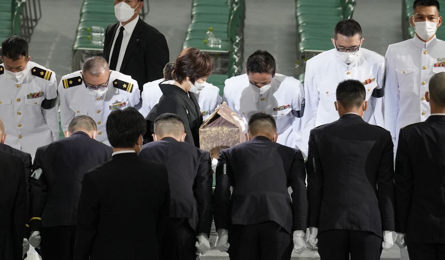 Akie Abe, wife of former Japanese Prime Minister Shinzo Abe, carries her husband&#x27;s urn, as she leaves his state funeral at Nippon Budokan, in Tokyo, Japan, Tuesday, Sept. 27, 2022. (AP Photo/Eugene Hoshiko, Pool)
