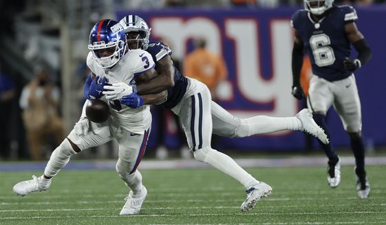 Dallas Cowboys cornerback Anthony Brown (3) strips the ball from New York Giants wide receiver Sterling Shepard (3) during the fourth quarter of an NFL football game, Monday, Sept. 26, 2022, in East Rutherford, N.J. (AP Photo/Adam Hunger) **FILE**