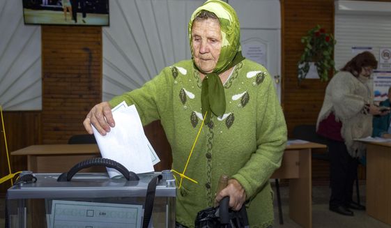 An elderly woman casts her ballot during a referendum in Luhansk, Luhansk People&#39;s Republic controlled by Russia-backed separatists, eastern Ukraine, Monday, Sept. 26, 2022. Voting began last Friday in four Moscow-held regions of Ukraine on referendums to become part of Russia. (AP Photo)