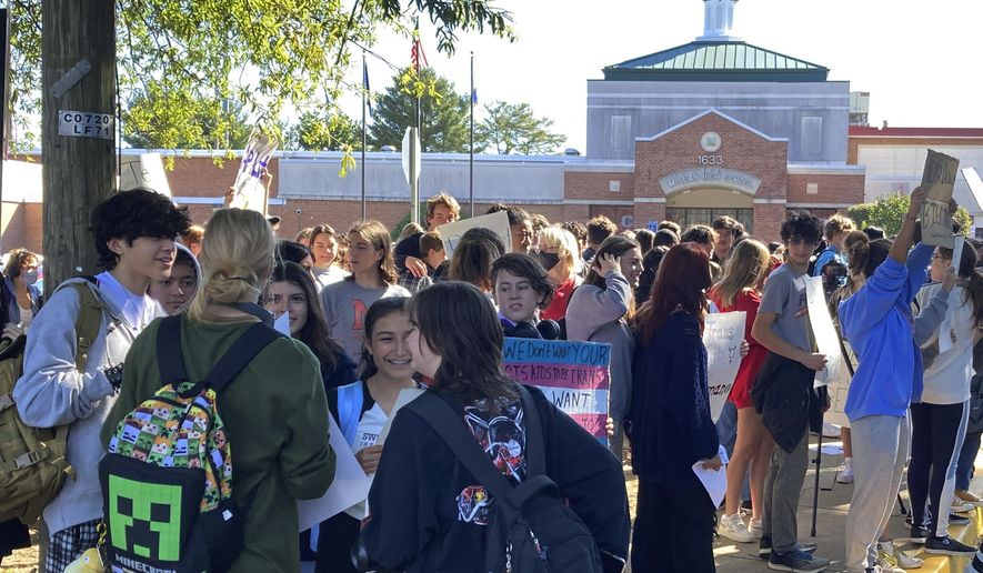 Students at McLean High School in McLean, Va., walk out of classes Tuesday, Sept. 27, 2022.  Student activists held school walkouts across Virginia on Tuesday to protest Republican Gov. Glenn Youngkin&#39;s proposed changes to the state&#39;s guidance on district policies for transgender students that would roll back some accommodations.  (AP Photo/Matthew Barakat)