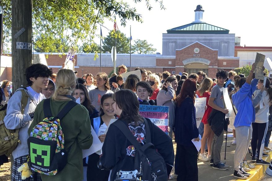 Students at McLean High School in McLean, Va., walk out of classes Tuesday, Sept. 27, 2022. Student activists held school walkouts across Virginia on Tuesday to protest Republican Gov. Glenn Youngkin's proposed changes to the state's guidance on district policies for transgender students that would roll back some accommodations. (AP Photo/Matthew Barakat)