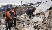People clear the rubble after a Russian attack ruined a railway depot in Kharkiv, Ukraine, Wednesday, Sept. 28, 2022. (AP Photo/Andrii Marienko)