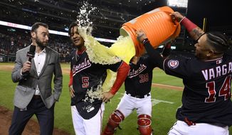 Washington Nationals&#39; CJ Abrams (5) gets doused by Ildemaro Vargas (14) and Tres Barrera (38) after the team&#39;s baseball game against the Atlanta Braves, Wednesday, Sept. 28, 2022, in Washington. Abrams hit a single to score Alex Call with the winning run. The Nationals won 3-2 in 10 innings. (AP Photo/Nick Wass)