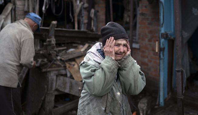 Valentina Bondarenko reacts as she stands with her husband Leonid outside their house that was heavily damaged after a Russian attack in Sloviansk, Ukraine, Tuesday, Sept. 27, 2022. The 78-year-old woman was in the garden and fell on the ground at the moment of the explosion. &amp;quot;Everything flew and I started to run away&amp;quot;, says Valentina. (AP Photo/Leo Correa)
