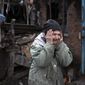 Valentina Bondarenko reacts as she stands with her husband Leonid outside their house that was heavily damaged after a Russian attack in Sloviansk, Ukraine, Tuesday, Sept. 27, 2022. The 78-year-old woman was in the garden and fell on the ground at the moment of the explosion. &amp;quot;Everything flew and I started to run away&amp;quot;, says Valentina. (AP Photo/Leo Correa)