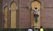 Workers from Specialized Performance Delivered 24:7 board up the windows on the historical Henry B. Plant Hall on the campus of the University of Tampa ahead of Hurricane Ian Tuesday, Sept. 27, 2022, in Tampa, Fla. Ian is predicted to make landfall somewhere on Florida&#39;s west coast. (AP Photo/Chris O&#39;Meara)