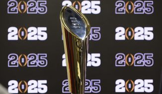 The National Championship Trophy is displayed following a news conference Aug. 16, 2022, in Atlanta, announcing that the CFP National Championship NCAA college football game will be played at Mercedes-Benz Stadium in 2025. The conference commissioners who manage the College Football Playoff met for almost seven hours Tuesday, Sept. 27, to work on expanding the postseason system from four to 12 teams as soon as the 2024 season. There is still much work to be done. (Jason Getz/Atlanta Journal-Constitution via AP, File) **FILE**