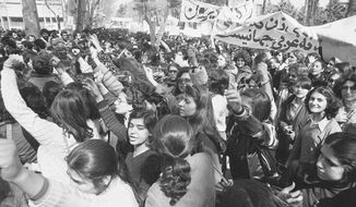 Iranian women demonstrate for equal rights, March 12, 1979. Iran&#39;s Islamic Republic requires women to cover up in public. But many Iranian women have long played a game of cat-and-mouse with authorities as a younger generation wears their veils more loosely or skirts requirements for conservative dress. (AP Photo/Richard Tomkins, File)