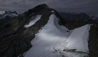 Parts of the ice of the Corvatsch glacier are covered with a tarpaulin, near Samedan, Switzerland, Monday, Sept. 5, 2022. Glaciologists have stopped their program to measure the glacier. The decision has already been taken in 2019 and the hot summer of 2022 has led to &amp;quot;extreme losses of ice&amp;quot; and the end of the program. The covered part of the glacier is used as a ski slope in winter. (Gian Ehrenzeller/Keystone via AP,file)
