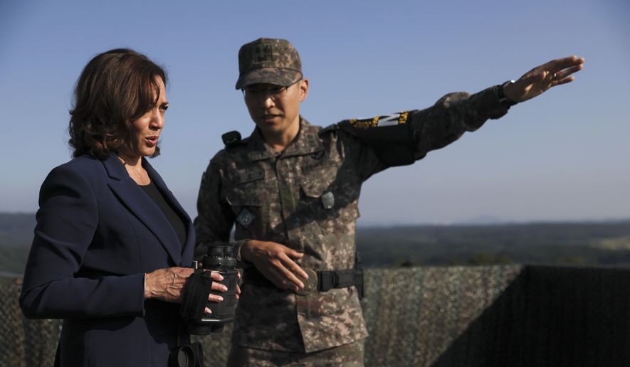 U.S. Vice President Kamala Harris, left, holds binoculars at the military observation post as she visits the Demilitarized Zone (DMZ) separating the two Koreas, in Panmunjom, South Korea Thursday, Sept. 29, 2022. (Leah Millis/Pool Photo via AP)