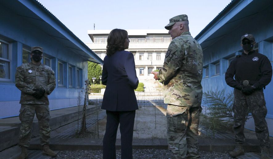 U.S. Vice President Kamala Harris, center left, stands next to the demarcation line at the Demilitarized Zone (DMZ) separating the two Koreas, in Panmunjom, South Korea Thursday, Sept. 29, 2022. (Leah Millis/Pool Photo via AP)