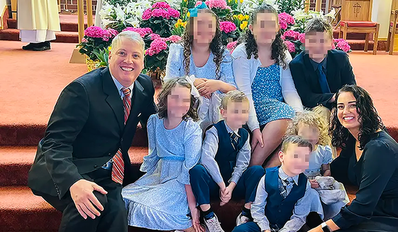 Pennsylvania pro-life activist Mark Houck, shown with his wife Ryan-Marie Houck and their seven children, was arrested in an FBI raid on his home Sept. 23, 2022, for alleged violations of the Freedom of Access to Clinic Entrances Act. (Photo courtesy of Thomas More Society) **FILE**