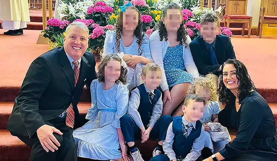 Pennsylvania pro-life activist Mark Houck, shown with his wife Ryan-Marie Houck and their seven children, was arrested in an FBI raid on his home Sept. 23, 2022, for alleged violations of the Freedom of Access to Clinic Entrances Act. (Photo courtesy of Thomas More Society) **FILE**