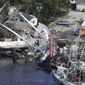In this aerial photo, damaged boats and debris rest against the shore in the aftermath of Hurricane Ian, Thursday, Sept. 29, 2022, in Fort Myers, Fla.  (AP Photo/Wilfredo Lee)