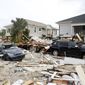 Remnants of damaged homes and flooded vehicles are seen in Fort Myers Beach, Fla., on Thursday, Sep 29, 2022, following Hurricane Ian. (Douglas R. Clifford/Tampa Bay Times via AP)