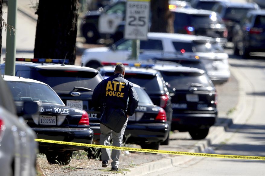 An officer from Alcohol Tobacco and Firearms heads to a complex of schools on Fountain Street following a shooting at a school campus in Oakland, Calif., on Wednesday, Sept. 28, 2022. (Ray Chavez/Bay Area News Group via AP)