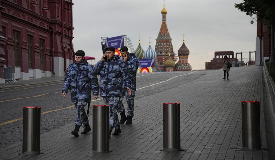 Policemen walk at Red Square with the St. Basil&#x27;s Cathedral and Lenin Mausoleum in the background ahead of a planned concert in Moscow, Russia, Thursday, Sept. 29, 2022. The Kremlin said that Russian President Vladimir Putin and the leaders of the four regions of Ukraine that held a referendum on joining Russia will attend a ceremony to sign documents on the regions&#x27; incorporation into Russia, which will be followed by a big concert on Red Square. (AP Photo/Alexander Zemlianichenko)