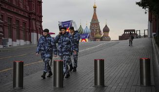 Policemen walk at Red Square with the St. Basil&#39;s Cathedral and Lenin Mausoleum in the background ahead of a planned concert in Moscow, Russia, Thursday, Sept. 29, 2022. The Kremlin said that Russian President Vladimir Putin and the leaders of the four regions of Ukraine that held a referendum on joining Russia will attend a ceremony to sign documents on the regions&#39; incorporation into Russia, which will be followed by a big concert on Red Square. (AP Photo/Alexander Zemlianichenko)