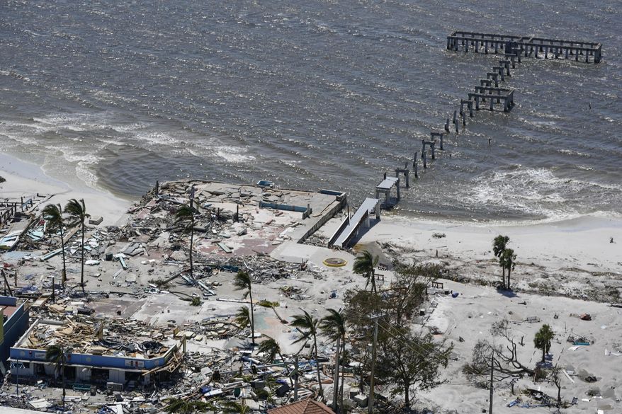 The remnant of a pier is seen in the wake of Hurricane Ian, Thursday, Sept. 29, 2022, in Fort Myers Beach, Fla. (AP Photo/Wilfredo Lee)