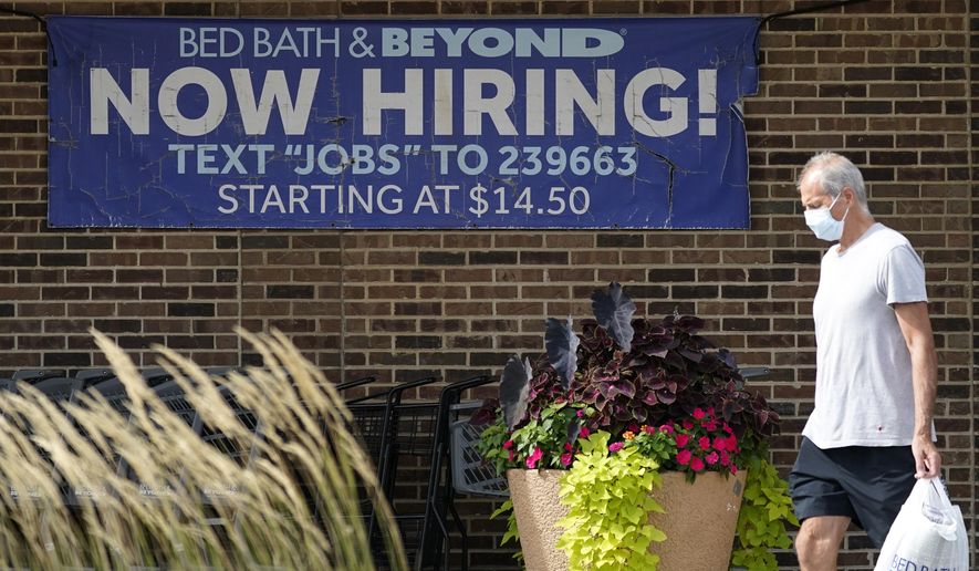 Hiring sign is displayed in Deerfield, Ill., Wednesday, Sept. 21, 2022. The number of Americans filing for jobless benefits dropped last week, a sign that few companies are cutting jobs despite high inflation and a weak economy. Applications for unemployment benefits for the week ending Sept. 24 fell by 16,000 to 193,000, the Labor Department reported Thursday, Sept. 29.   (AP Photo/Nam Y. Huh)