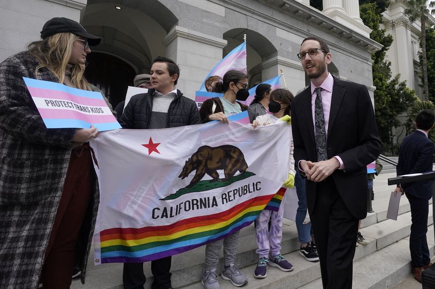 State Sen. Scott Wiener, D-San Francisco, right, prepares to announce his proposed measure to provide legal refuge to displaced transgender youth and their families during a news conference in Sacramento, Calif., Thursday, March 17, 2022. On Thursday, Sept. 29, 2022, Gov. Gavin Newsom signed Wiener&#x27;s bill into law. (AP Photo/Rich Pedroncelli, File)