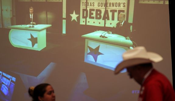 Supporters of Texas Gov. Greg Abbott watch his debate with Texas Democratic gubernatorial candidate Beto O&#39;Rourke, Friday, Sept. 30, 2022, in McAllen, Texas. (AP Photo/Eric Gay)