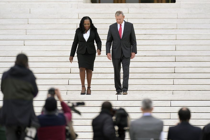 Supreme Court Associate Justice Ketanji Brown Jackson walks with Chief Justice of the United States John Roberts down the front steps, following her formal investiture ceremony at the Supreme Court in Washington, Friday, Sept. 30, 2022. (AP Photo/Carolyn Kaster)