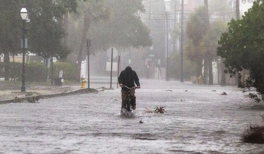 Flood waters cover the street of the South Battery in Charleston, S.C., during Hurricane Ian on Friday, Sept. 30, 2022. (Brad Nettles/The Post and Courier via AP)