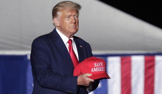 Former President Donald Trump tosses caps to the crowd as he holds a rally on Sept. 23, 2022, in Wilmington, N.C. (AP Photo/Chris Seward) **FILE**