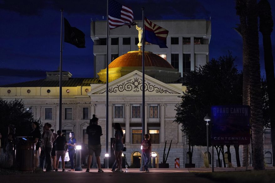 Protesters gather outside the Capitol to voice their dissent with an abortion ruling, Friday, Sept. 23, 2022, in Phoenix. An Arizona judge ruled the state can enforce a near-total ban on abortions that has been blocked for nearly 50 years. The law was first enacted decades before Arizona became a state in 1912. (AP Photo/Matt York, File)