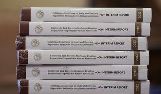 Copies of the interim report issued by California&#39;s first-in-the-nation task force on reparations for African Americans are seen at the Capitol in Sacramento, Calif., Thursday, June 16, 2022. (AP Photo/Rich Pedroncelli, File)