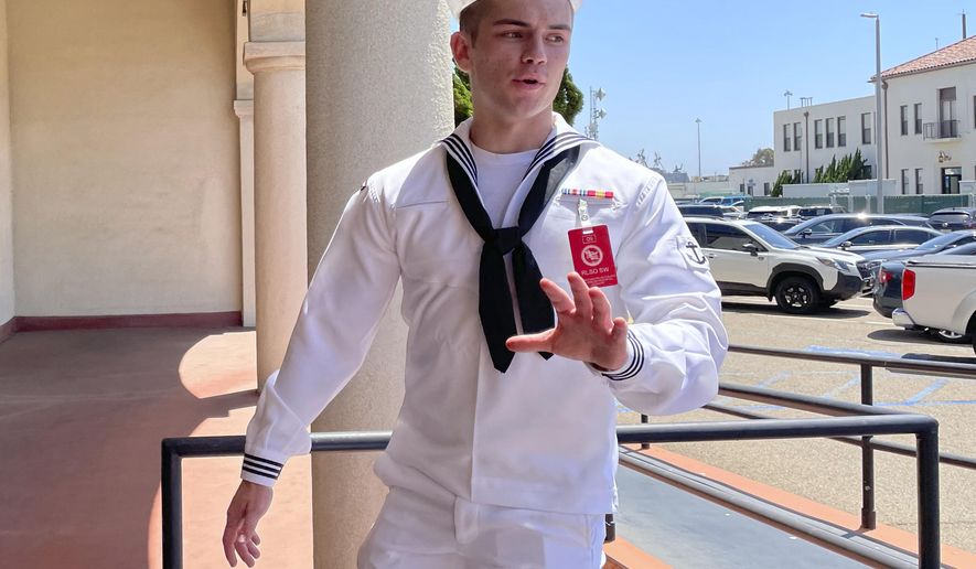US Navy sailor Ryan Sawyer Mays walks past reporters at Naval Base San Diego before entering a Navy courtroom, Aug. 17, 2022, in San Diego. No one disputes that the Navy shares blame for the loss of the USS Bonhomme Richard, the $1.2 billion amphibious assault ship that was consumed by flames in San Diego in July 2020 as officers failed to respond quickly and its crew struggled with broken equipment. But none of that would not have happened, according to prosecution closing arguments, Thursday, Sept. 29, 2022, without Ryan Sawyer Mays. (AP Photo/Julie Watson, File)