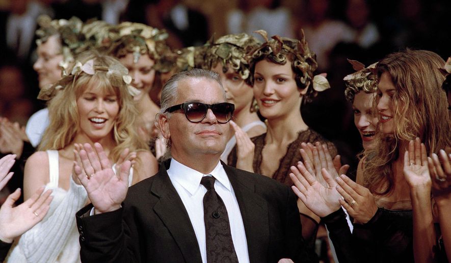 German fashion designer Karl Lagerfeld acknowledges the applause of his models at the end of the show he designed for the French fashion house Chanel, for the 1993-94 Fall-Winter haute couture collection in Paris, July 20, 1993. US Vogue Editor-in-Chief Anna Wintour convened a huddle of top Paris Fashion Week insiders Friday to announce that the theme of next year&#39;s annual Met Gala will be the work of the late Karl Lagerfeld. (AP Photo/Lionel Cironneau, File)