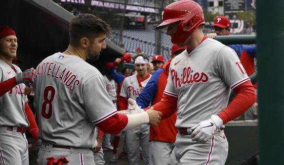Philadelphia Phillies&#39; Rhys Hoskins, right, celebrates his home run with Nick Castellanos (8) during the first inning in the first baseball game of a doubleheader against the Washington Nationals, Friday, Sept. 30, 2022, in Washington. (AP Photo/Nick Wass)