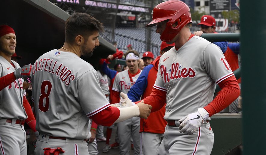Philadelphia Phillies&#39; Rhys Hoskins, right, celebrates his home run with Nick Castellanos (8) during the first inning in the first baseball game of a doubleheader against the Washington Nationals, Friday, Sept. 30, 2022, in Washington. (AP Photo/Nick Wass)