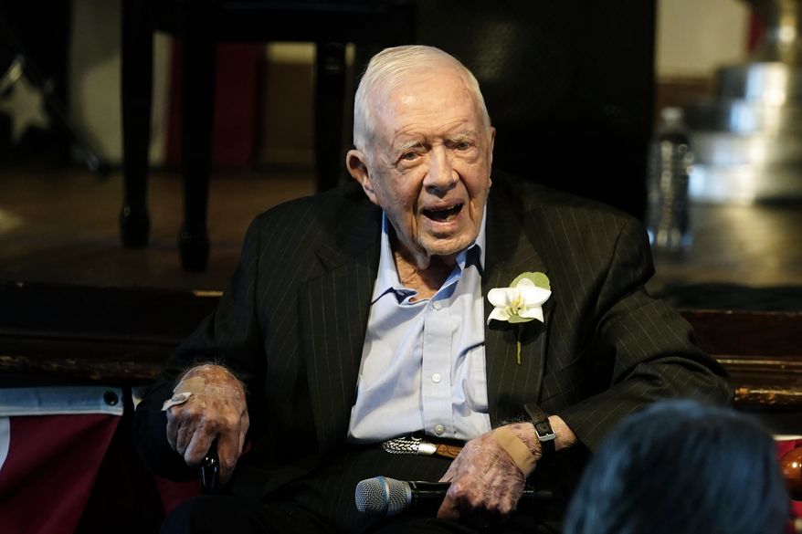 Former President Jimmy Carter reacts as his wife Rosalynn Carter speaks during a reception to celebrate their 75th wedding anniversary Saturday, July 10, 2021, in Plains, Ga.. (AP Photo/John Bazemore, Pool, File)