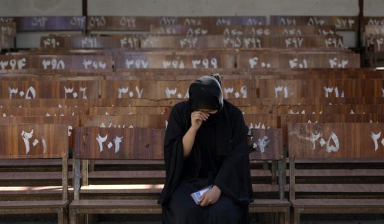 A 19-year old Hazara Afghan girl sits and cries on the bench she was sitting on, during Friday&#39;s suicide bomber attack on a Hazara education center, in Kabul, Afghanistan, Saturday, Oct. 1, 2022. Afghanistan&#39;s Hazaras, who are mostly Shiite Muslims, have been the target of a brutal campaign of violence for the past several years. (AP Photo/Ebrahim Noroozi)