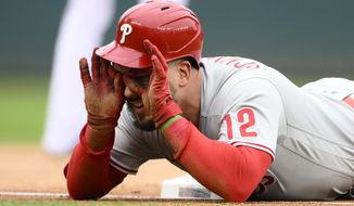 Philadelphia Phillies&#x27; Kyle Schwarber looks towards the dugout after he tripled during the first inning of the first baseball game of a doubleheader against the Washington Nationals, Saturday, Oct. 1, 2022, in Washington. (AP Photo/Nick Wass)